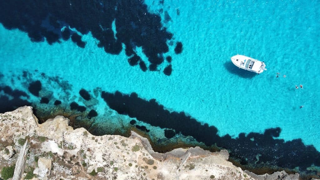 A scenic view of vineyards on Mount Etna with Vulcano and Stromboli islands in the background on the Sicily Wine Tour and Wellness